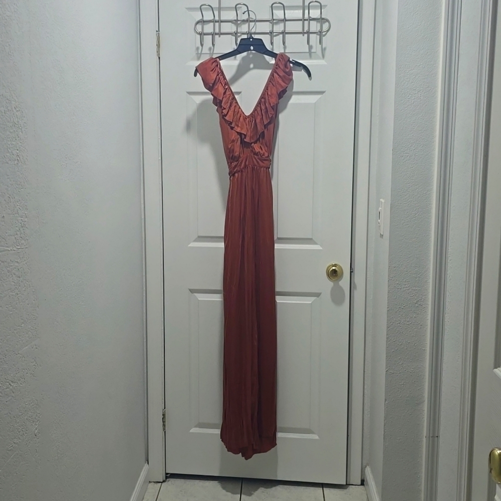 Wide leg flowy jumpsuit with ruffles at the neck